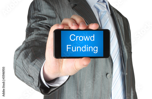 Photo: Businessman holds smart phone with crowd funding words Businessman holds smart phone with crowd funding words