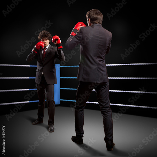 Photo: Two young businessman boxing Two young businessman boxing