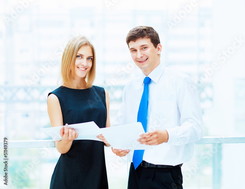 Photo: Two young business collegues. Two young business collegues.