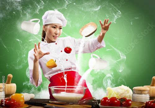 Photo: Asian female cooking with magic Asian female cooking with magic