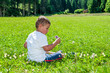 child sat on the lawn
