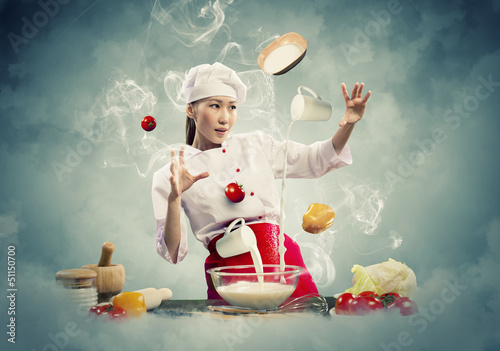Photo: Asian female cooking with magic Asian female cooking with magic