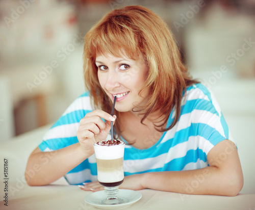 Photo: Smiling woman drinking coffee Smiling woman drinking coffee