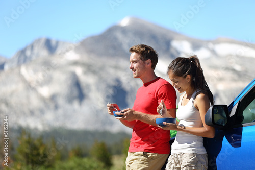 Photo: Couple on car road trip travel in Yosemite eating Couple on car road trip travel in Yosemite eating