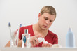 Young man shaving at home
