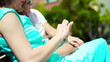 Woman hands texting message on smartphone in the park, steadicam