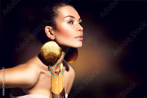 Photo: Fashion Woman Portrait. Golden Jewels. Trendy Makeup Fashion Woman Portrait. Golden Jewels. Trendy Makeup