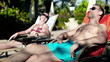 Young couple relaxing on sunbed and talking