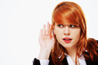 Photo: Business woman with hand to ear listening isolated Business woman with hand to ear listening isolated