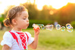 Child blowing soap bubbles.