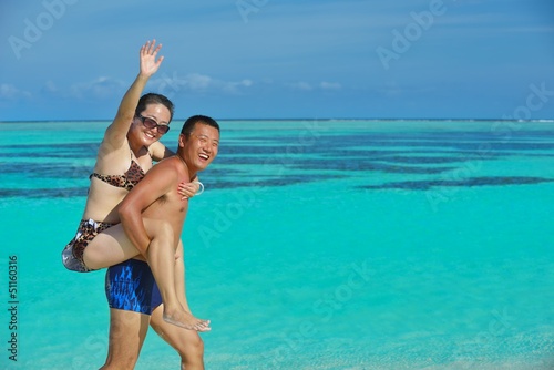 Photo: happy young couple enjoying summer on beach happy young couple enjoying summer on beach