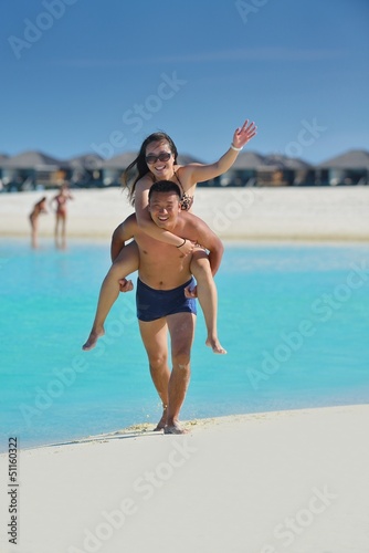 Photo: happy young couple enjoying summer on beach happy young couple enjoying summer on beach