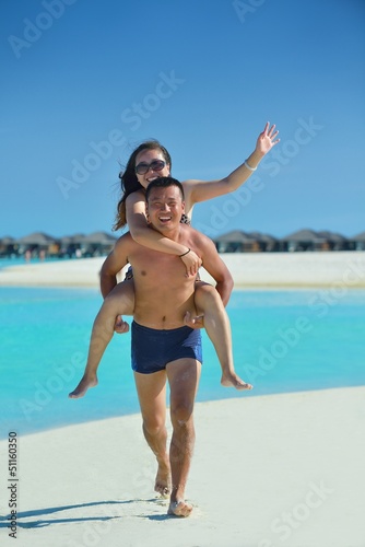 Photo: happy young couple enjoying summer on beach happy young couple enjoying summer on beach