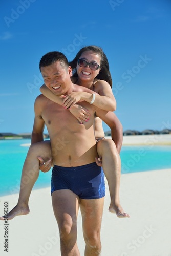Photo: happy young couple enjoying summer on beach happy young couple enjoying summer on beach