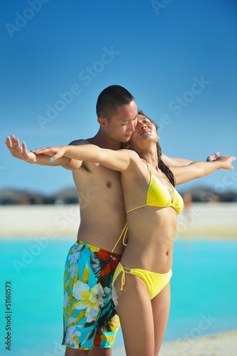 Photo: happy young couple enjoying summer on beach happy young couple enjoying summer on beach