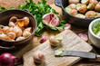 Filling snails with garlic butter and fresh herbs