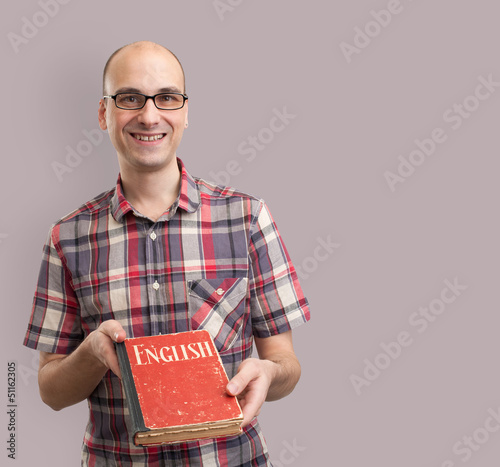 Photo: learning english. Male student with book learning english. Male student with book