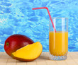 Ripe appetizing mango on woven napkin on water background