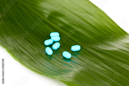 Photo: tablets on green leaf isolated on white tablets on green leaf isolated on white