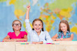 Back to school - elementary school pupil raising hand