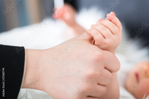 Photo: Little baby holding mothers hand Little baby holding mothers hand