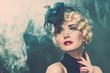 Elegant blond retro woman  wearing little hat 
