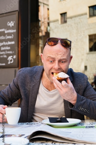 Photo: Surprised middle-aged man reading newspaper Surprised middle-aged man reading newspaper