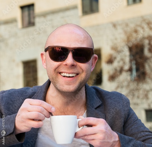 Photo: Cheerful middle-aged man with coffee cup Cheerful middle-aged man with coffee cup