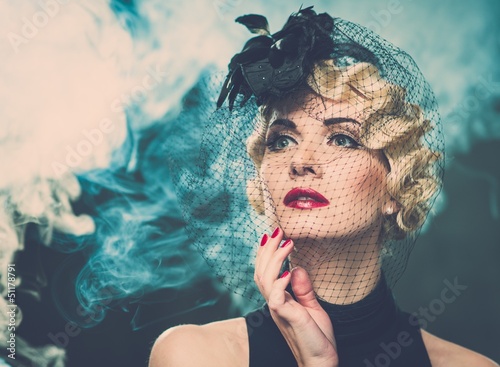 Photo: Elegant blond retro woman wearing little hat Elegant blond retro woman wearing little hat
