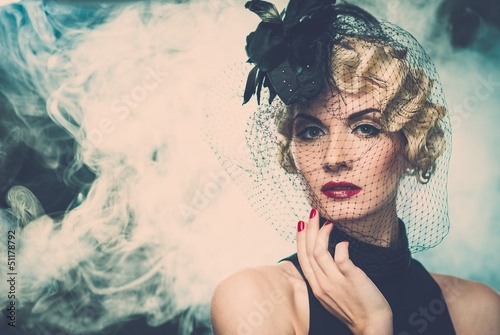 Photo: Elegant blond retro woman wearing little hat Elegant blond retro woman wearing little hat