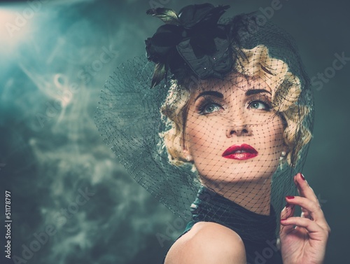 Photo: Elegant blond retro woman wearing little hat Elegant blond retro woman wearing little hat