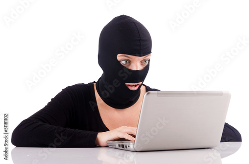 Photo: Hacker with computer wearing balaclava Hacker with computer wearing balaclava