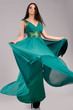 portrait of sexy girl  in green dress on gray background