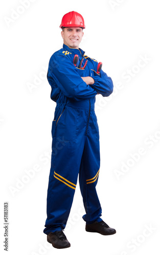 Photo: Young handsome mechanic with hard hat and tools and in overalls Young handsome mechanic with hard hat and tools and in overalls