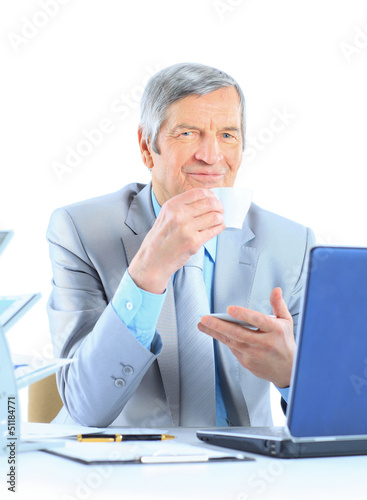 Photo: The businessman at the age of drinking coffee The businessman at the age of drinking coffee