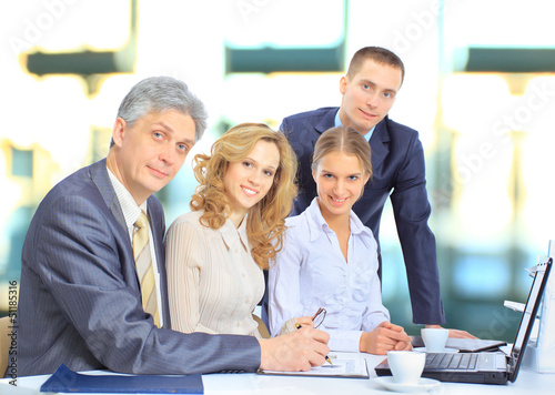 Photo: Group of businessmen discussing income. Group of businessmen discussing income.