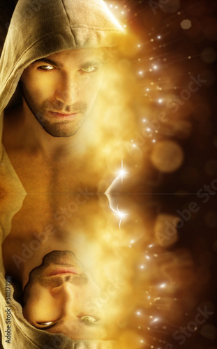 Photo: Fantastical portrait of a handsome hero type man in hood Fantastical portrait of a handsome hero type man in hood