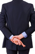 Business man with fingers crossed.