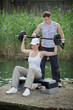 Detaily fotografie woman exercising with personal trainer with barbell - outdoor