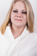 cut fresh young woman in a bathrobe in a spa