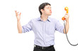 Photo: A guy in love holding a telephone tube and giving kisses A guy in love holding a telephone tube and giving kisses