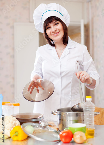Photo: cook woman with ladle cook woman with ladle