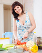 woman cutting the tomatoes in home