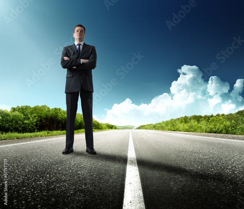 Photo: business man stay on the road business man stay on the road