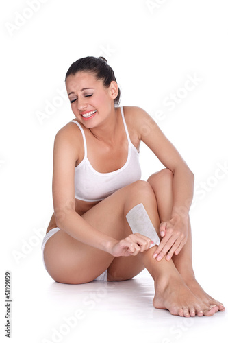 Photo: Woman depilate for legs with waxing Woman depilate for legs with waxing