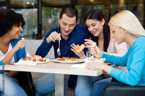 Photo: Young people having lunch in restaurant Young people having lunch in restaurant