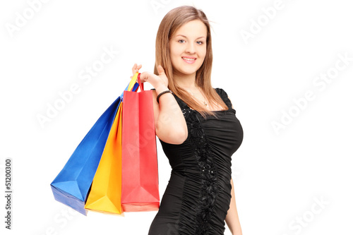 Photo: A young female holding shopping bags A young female holding shopping bags