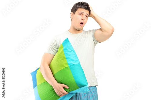 Photo: A young man in pajamas feeling sleepy A young man in pajamas feeling sleepy
