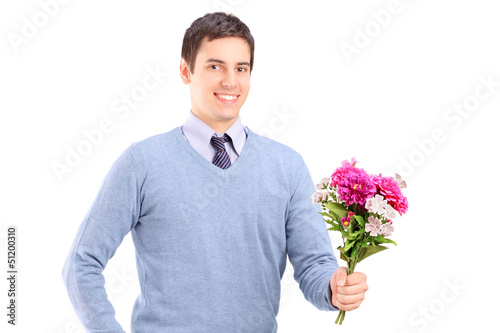 Photo: A young romantic man holding a bouquet of flowers A young romantic man holding a bouquet of flowers