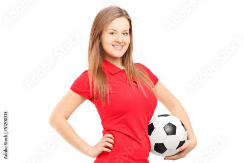 Photo: A young smiling female holding a soccer ball A young smiling female holding a soccer ball